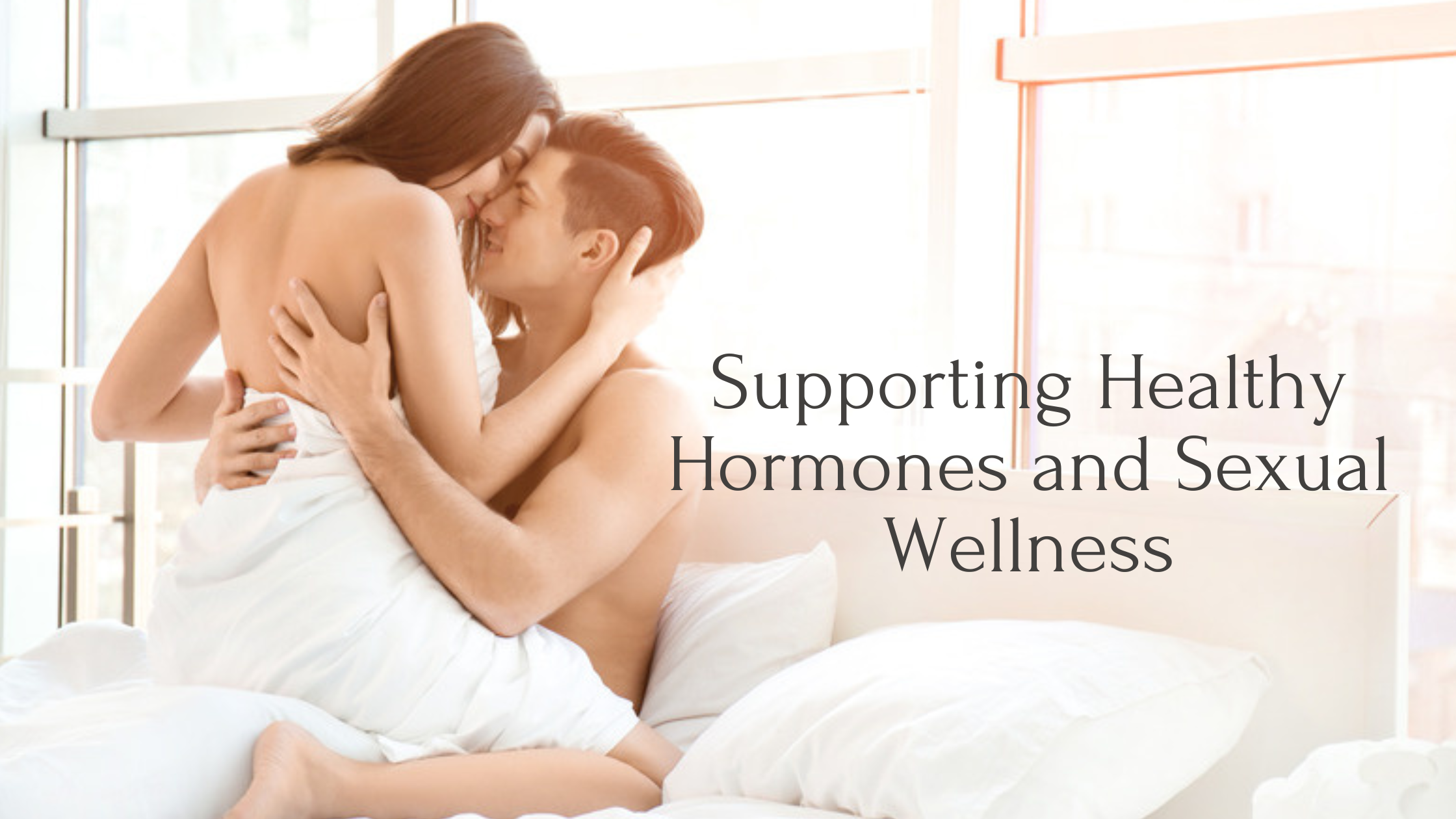 A couple embracing intimately in bed, representing the connection between healthy hormones and sexual wellness.